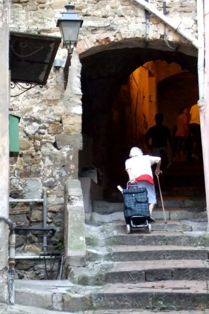 Old lady climbing the stairs in San Remo