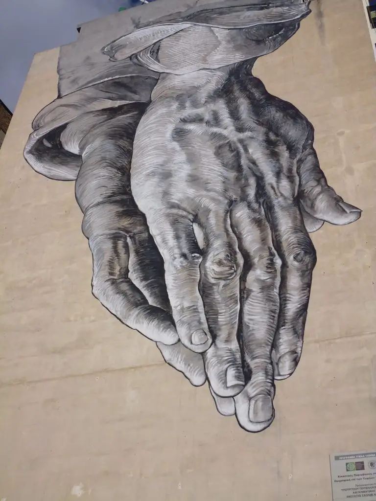 Praying Hands streetart in Pireos St, Athens, Greece. Life Beyond Borders