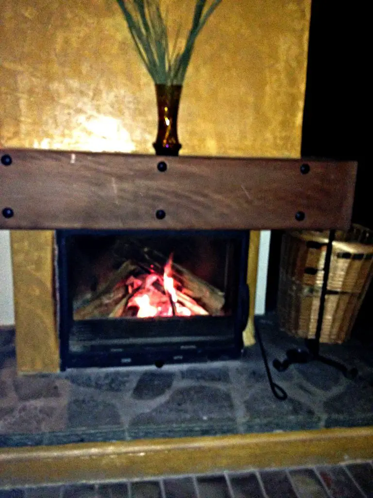 Log fire at the foot of your bed at Montanema Handmade Village