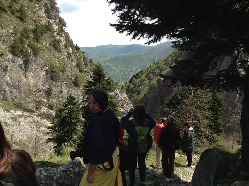 The travel bloggers hiking down to the waterfalls and stopping en-route to admire the scenery