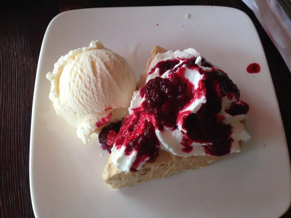 Peanut butter pie with raspberry compote, cream and ice cream