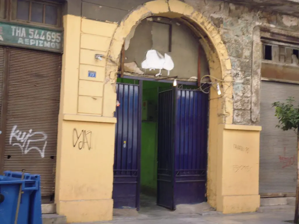 It may look like a nice doorway - it is, in fact, an entry to a brothel. Street art tour - Athens, Greece. Life Beyond Borders 