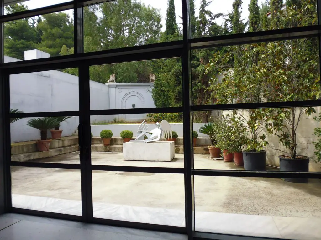 Inside the exhibition space looking out to the gardens at Vorres Museum