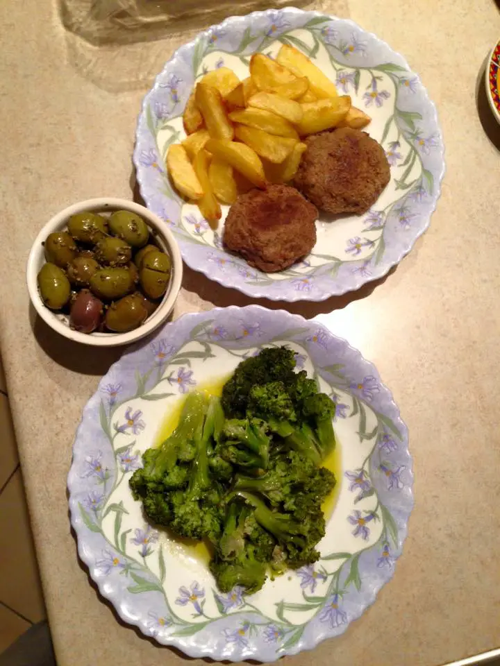 Homemade meatballs and homemade fries with broccoli in lemon and olive oil - and olives 'from the village'