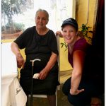 Old Greek woman and Bex of Life Beyond Borders at Alexandra’s Taverna on Kastellorizo island Greece. LfeBeyondBorders